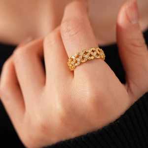 Macro shot of 18k gold plated mesh ring with zircon crystals in hollow floral pattern