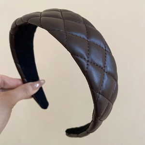 Detail shot of brown quilted leather headband with elegant rhombus texture pattern
