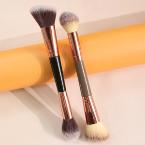 Dual-ended contour brush with rose gold ferrule on minimalist aesthetic background