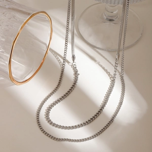 Double-layered silver stainless steel necklace featuring snake and cuban chain styles