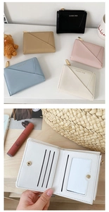 Close-up of minimalist women's wallet showing multiple card slots and clear ID window