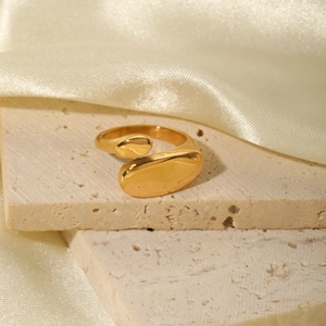 Irregular flat open adjustable ring in 18k gold plated titanium steel on travertine