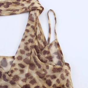Detailed close-up of leopard print sheer mesh bodysuit with fine spaghetti straps