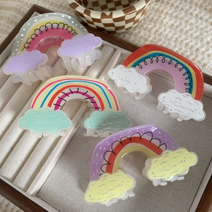 Cute acrylic rainbow and cloud hair clips set in a beige jewelry box for women