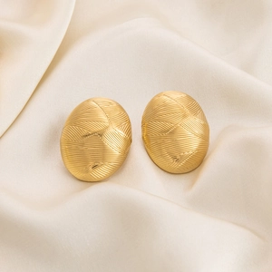 Detailed close-up of 18K gold-plated oval earrings with a 3D woven texture on white silk