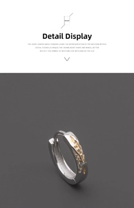 Detail view of silver hoop earring with irregular gold embossed texture and vintage finish