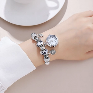 Silver beaded bracelet watch for women featuring crown and heart charms in a lifestyle setting