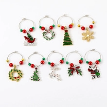 Detail view of nine Christmas wine glass charms with enamel holiday charms and colorful beads