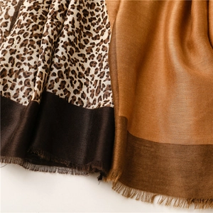 Detail of leopard print and camel solid color splicing scarf with delicate fringe edges