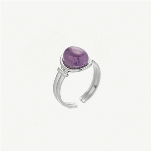 Detail of silver-toned open ring featuring an oval purple gemstone and dual-band design