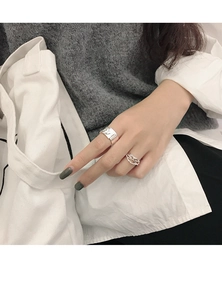 Close-up of S925 sterling silver open rings with irregular rock texture and woven style