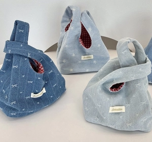 Three Japanese style denim knot bags with star patterns and red checkered lining