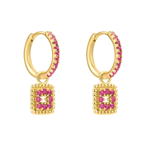 Detailed close-up of gold hoop earrings with ruby zircon pavé setting and rectangular charms