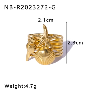 Macro detail of 18K gold-plated starfish and seashell ring with precise dimensions