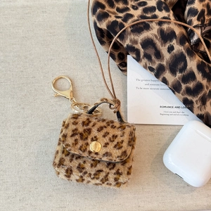 Detail of leopard print plush mini bag pendant with gold metal hardware and charging port