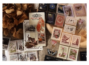 Close-up of vintage PET stickers featuring plants and animals on a rustic linen background