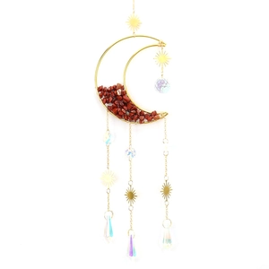 Detail of moon sun catcher with red crystal stones and hanging prism pendants