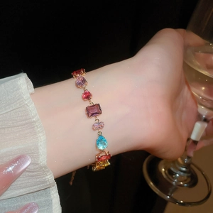 Detail shot of colorful zircon bracelet with mixed geometric gems and gold plating