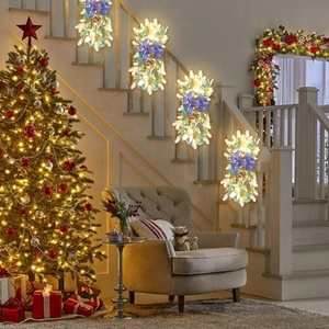 Close-up of four Christmas swags with blue bows, pine cones and LED lights on a staircase