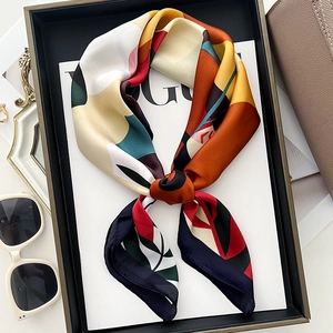 Retro geometric silk scarf with floral patterns on a magazine with fashion accessories