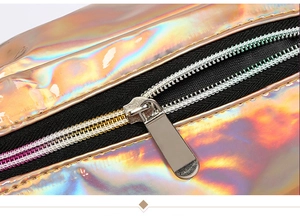 Detail of laser iridescent PVC waist bag showing smooth metal zipper and stitching texture