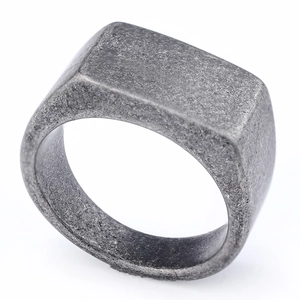 Detail view of rectangular stainless steel signet ring with vintage distressed texture
