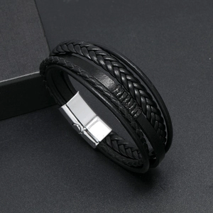 Detail of multi-layer woven black leather bracelet with silver magnetic metal clasp