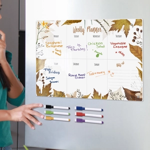 Magnetic acrylic weekly planner on fridge with six colored markers and floral design