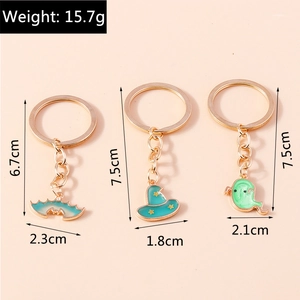 Detail view of light green enamel Halloween keychains showing precise sizes and weight