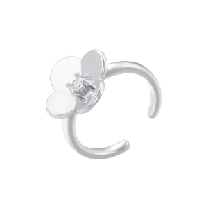 Detailed close-up of a silver clover ring featuring a centered crystal and open band design