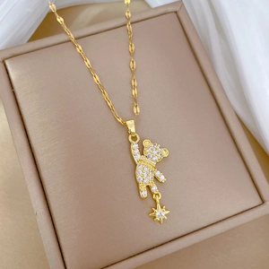 Luxury gold titanium bear necklace with sparkling crystals and star pendant on display