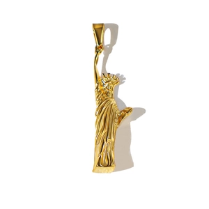 Detailed view of a vintage golden Statue of Liberty pendant in polished stainless steel