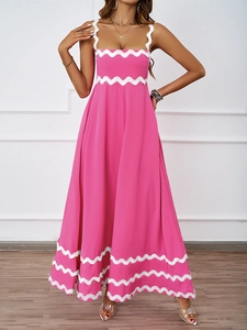Detail of summer pink maxi dress featuring white wavy trims and elegant thin shoulder straps