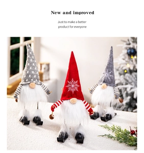 Three plush Christmas skiing gnomes with knitted hats and wooden skis on a snowy base