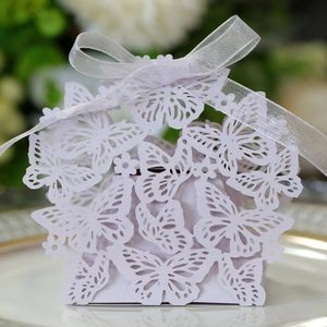Detailed laser-cut lavender butterfly candy box with an elegant white ribbon bow