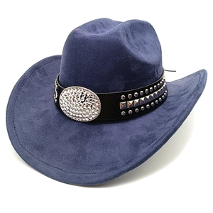 Close-up of blue suede cowboy hat featuring silver studs and a large crystal buckle