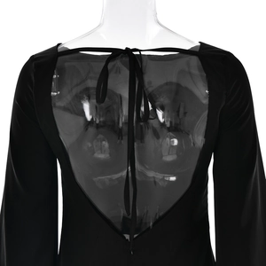 Back detail of elegant black dress featuring sheer mesh panel and tie neck design on mannequin