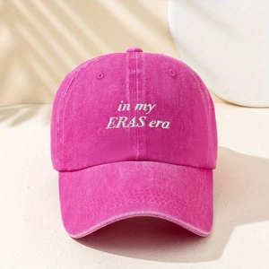 Close-up detail of 'in my ERAS era' white embroidery on a rose red washed cotton baseball cap