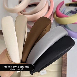 Macro detail of thick French sponge headbands in neutral and pastel matte fabrics