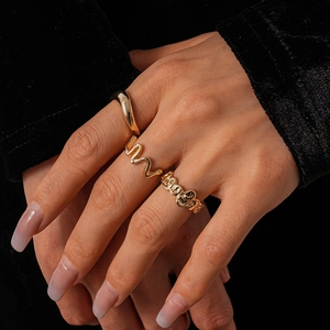 Detail of three-piece set with gold irregular wrinkled geometric rings worn on hand