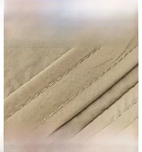 Detailed macro view of khaki camping sun hat showing durable twill fabric and reinforced stitching
