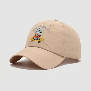 Close-up of beige kids baseball cap featuring breathable mesh and dinosaur embroidery