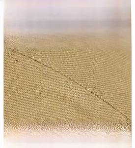 Detailed macro view of khaki cotton twill fabric texture and precise stitching on the cap