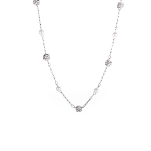 Detail of silver long necklace featuring white pearls and pavé crystal spheres on thin chain