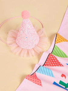 Close-up of pink glittery pet party hat with soft mesh trim and a pom-pom on top