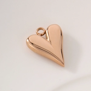 Detailed view of heart-shaped rose gold pendant with a polished metallic finish