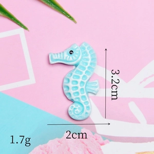 Detail view of a light blue resin seahorse charm with 3.2cm height and 2cm width dimensions