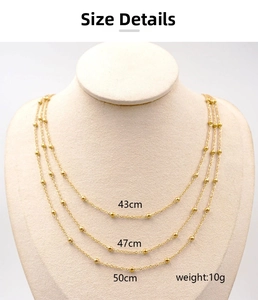 Detailed view of triple-layered gold titanium necklace showing 43, 47, 50cm chain lengths