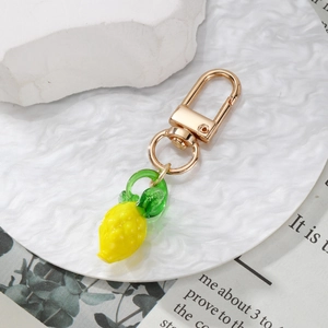 Mini lemon glass keychain with realistic fruit texture and gold metal lobster clasp
