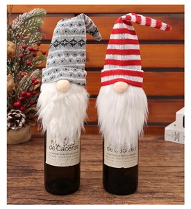 Detail of Christmas gnome wine bottle covers with knitted hats and white faux fur beards